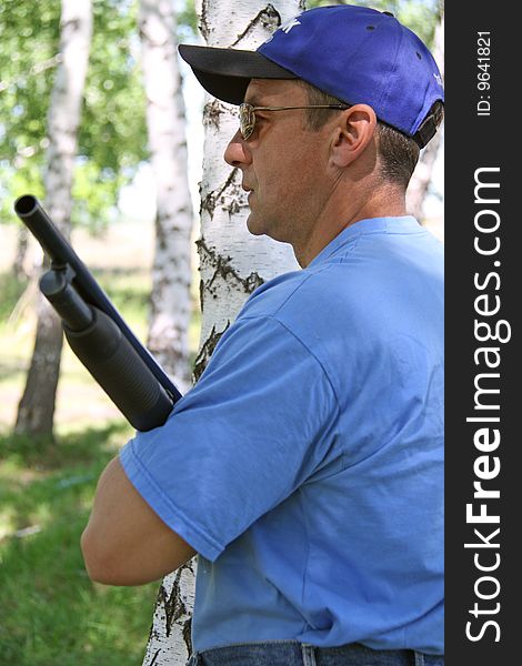 The man in dark glasses holds fire-arms. The man in dark glasses holds fire-arms