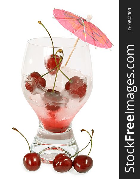 Glass with an alcoholic drink the fresh and frozen sweet cherry. Glass with an alcoholic drink the fresh and frozen sweet cherry