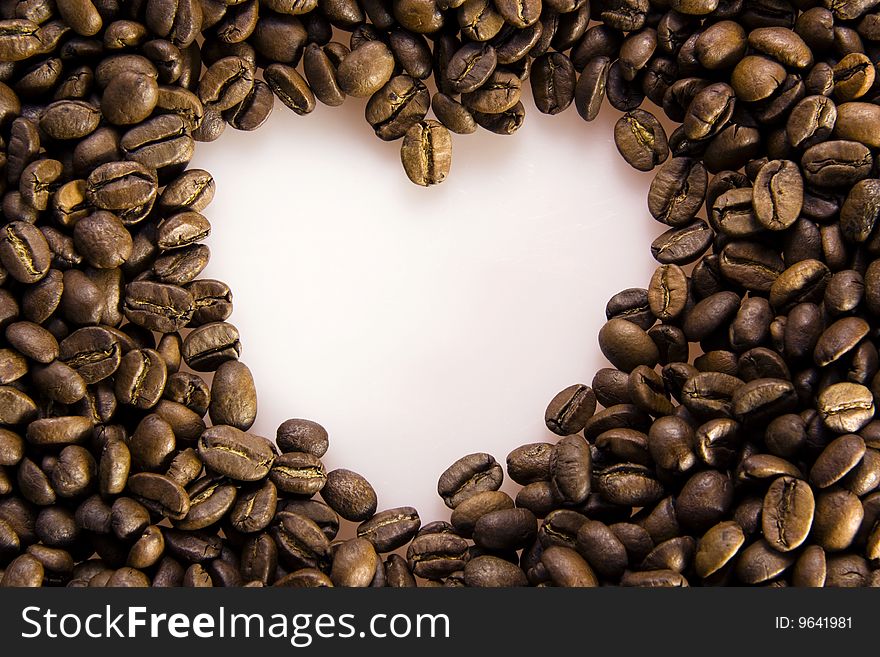 Coffee beans background forms heart. Coffee beans background forms heart