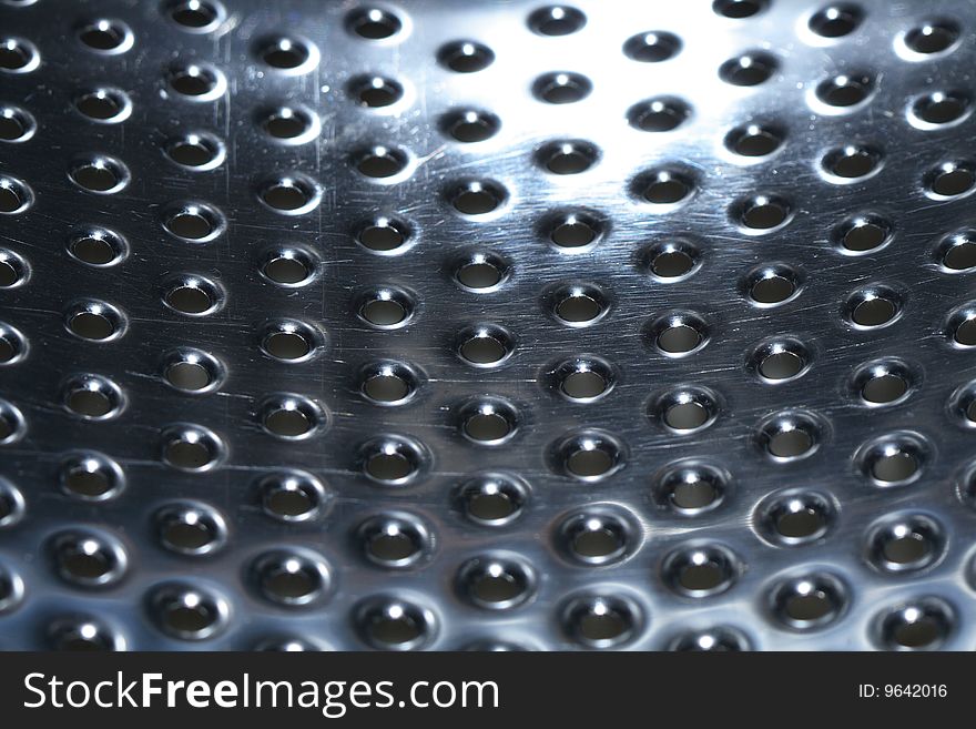 Abstract metal dark background with lot of small round holes standing in row. Abstract metal dark background with lot of small round holes standing in row