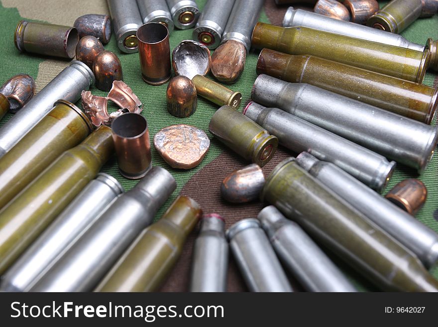 Bullets and sleeves on a camouflage background
