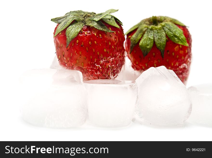 A fresh juicy strawberry is in ice. A fresh juicy strawberry is in ice