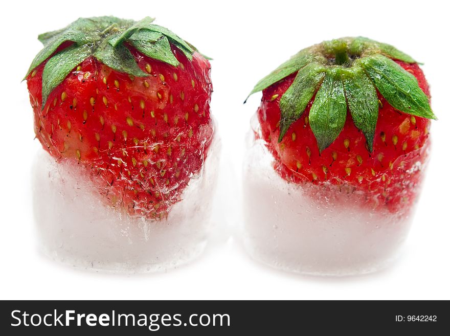 A fresh juicy strawberry is in ice. A fresh juicy strawberry is in ice