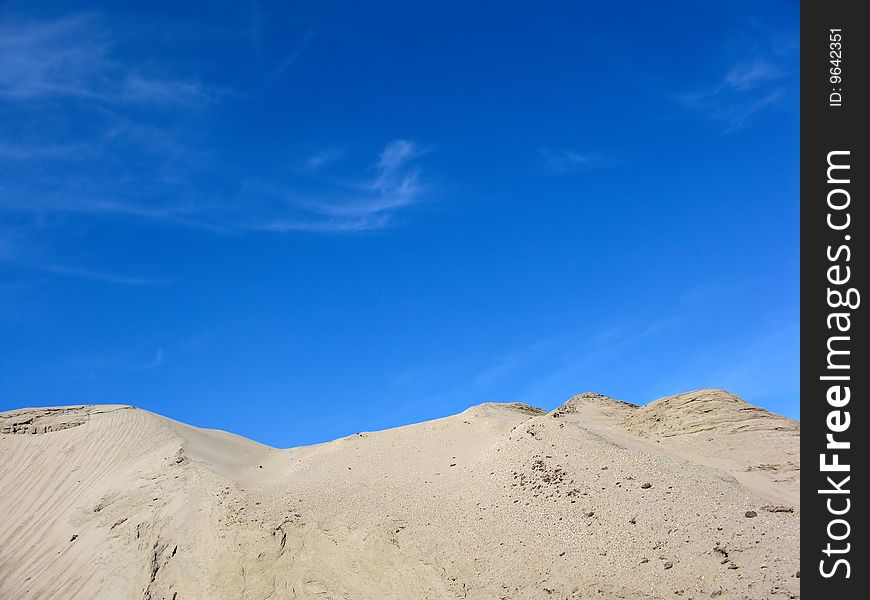 Sandy mountain in the dark blue sky