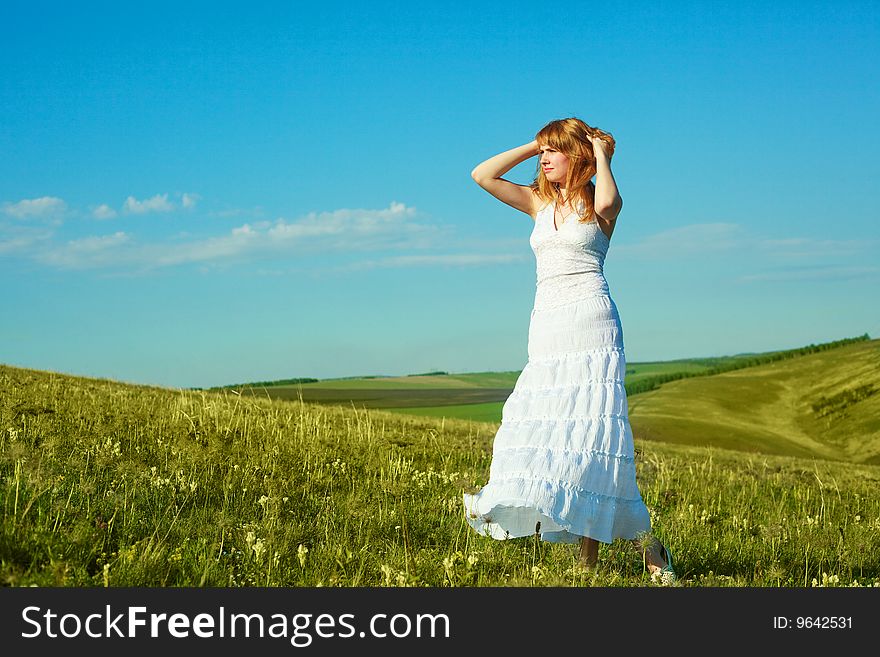 Beautiful girl wearing a white dress outdoor in summertime. Beautiful girl wearing a white dress outdoor in summertime