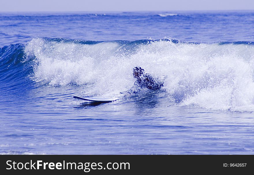 Woman surfing inside the wave