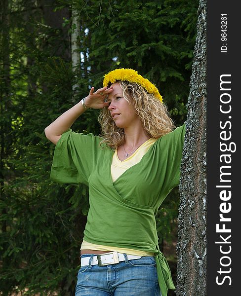 Curly girl with dandelion chain on head