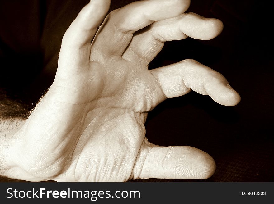 Hand of young man with black background