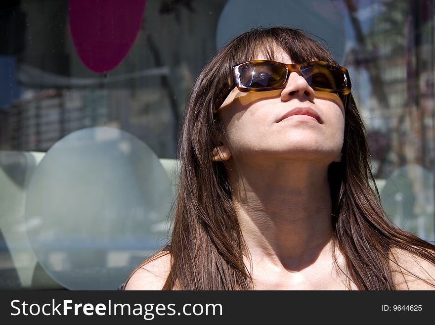 Woman with sun glasses enjoying the sun