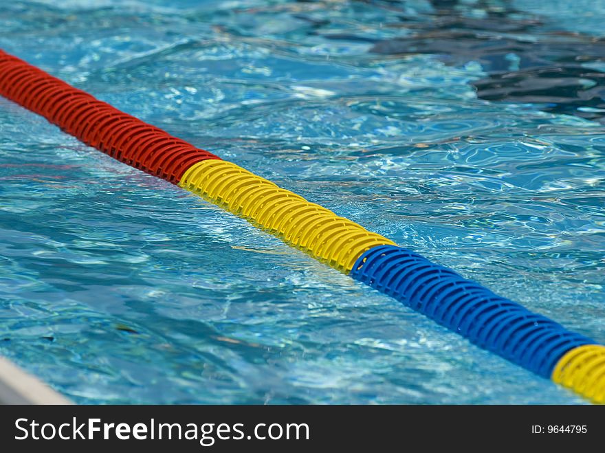 Swimming pool water surface detail with floaters. Swimming pool water surface detail with floaters.