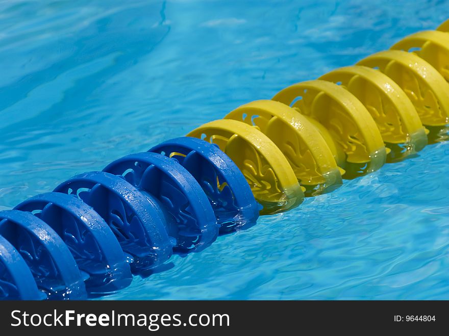 Swimming pool water surface detail with floaters. Swimming pool water surface detail with floaters.