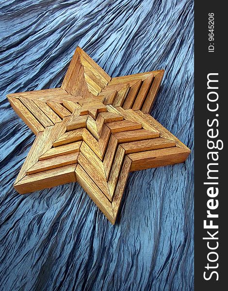 Handcrafted wooden stars on crinkled background. Handcrafted wooden stars on crinkled background