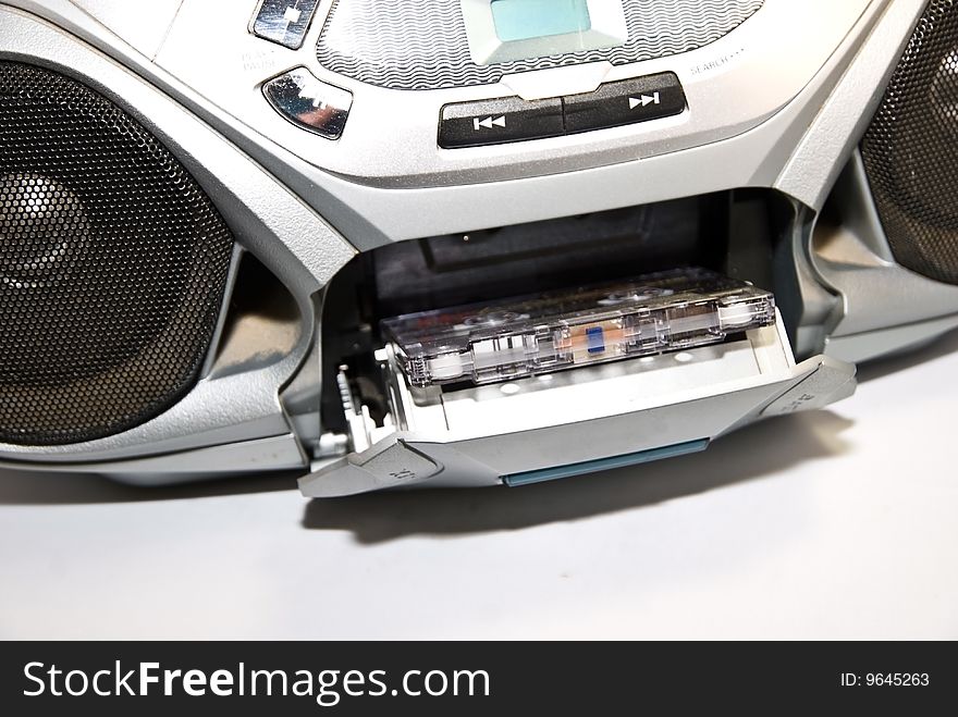 Closeup of a tape in a radio cassette tape player, a boom box.