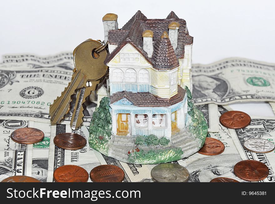 House with keys on dollar bills background