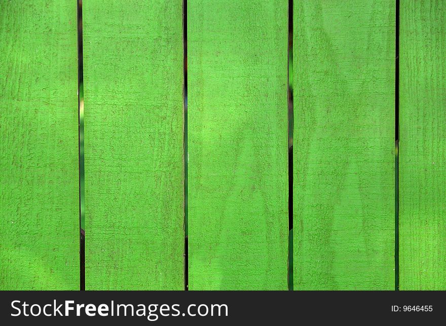 A wooden fence painted bright green. A wooden fence painted bright green.