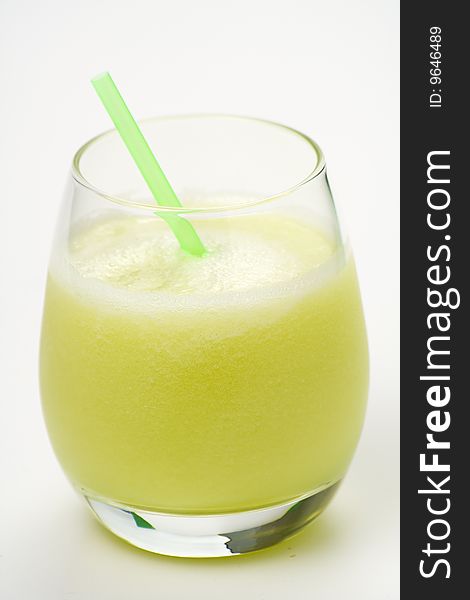 A delicious melon milkshake isolated over white. A delicious melon milkshake isolated over white