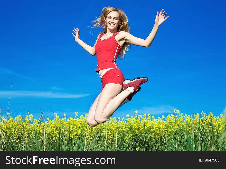 An image of a girl jumping on a background of blue sky