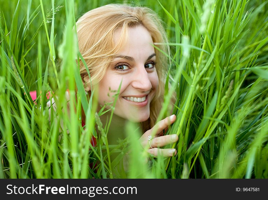 An image of young girl amongst green grass. An image of young girl amongst green grass