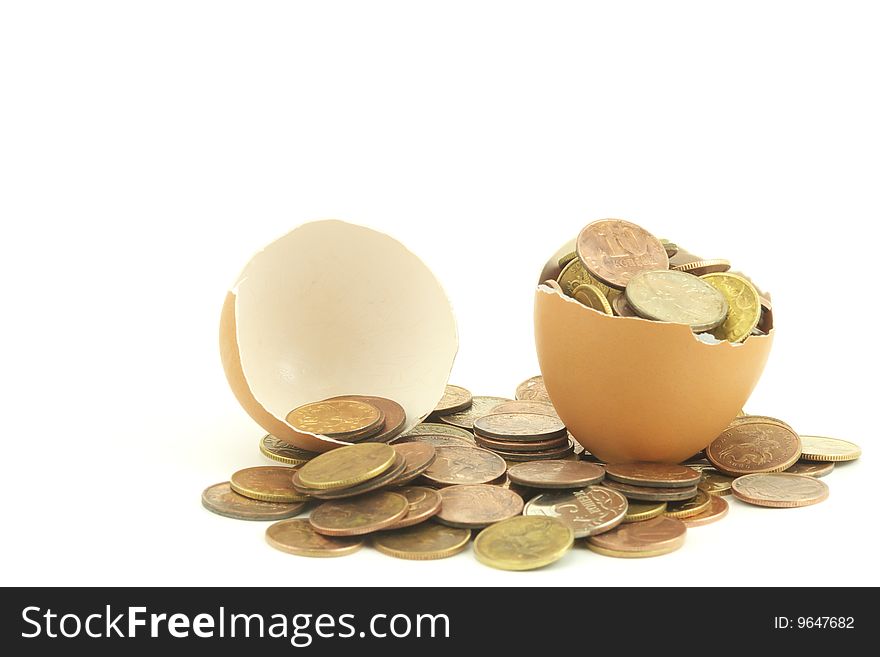 The coins in a egg. Close up. White background. The coins in a egg. Close up. White background