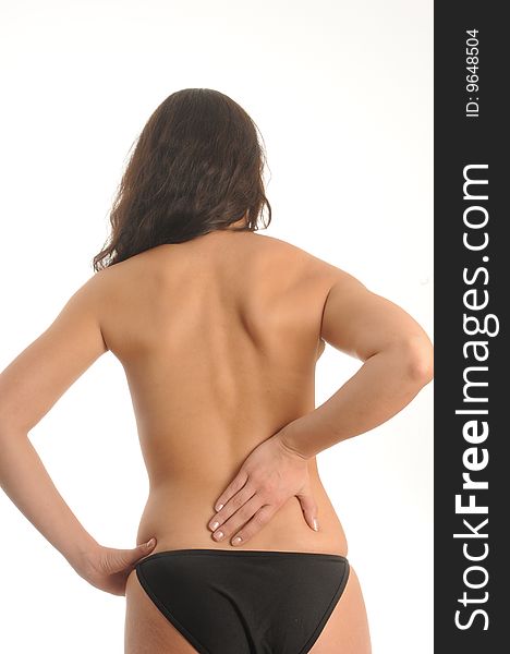 Young woman with back pain, isolated over white.
