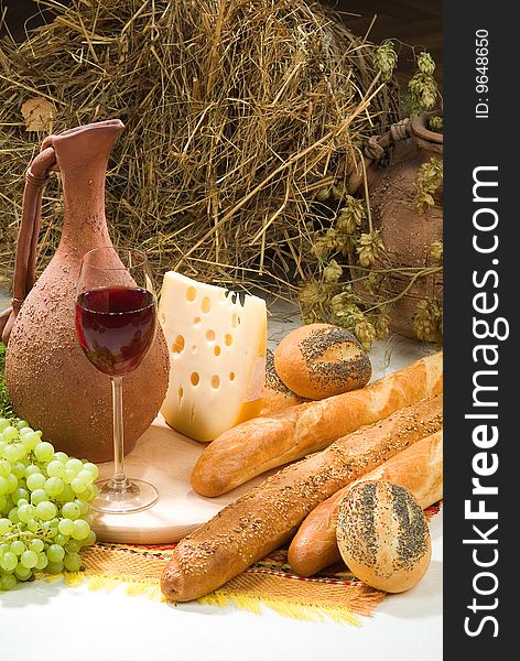 Bread with grape, wine and ceramic pot