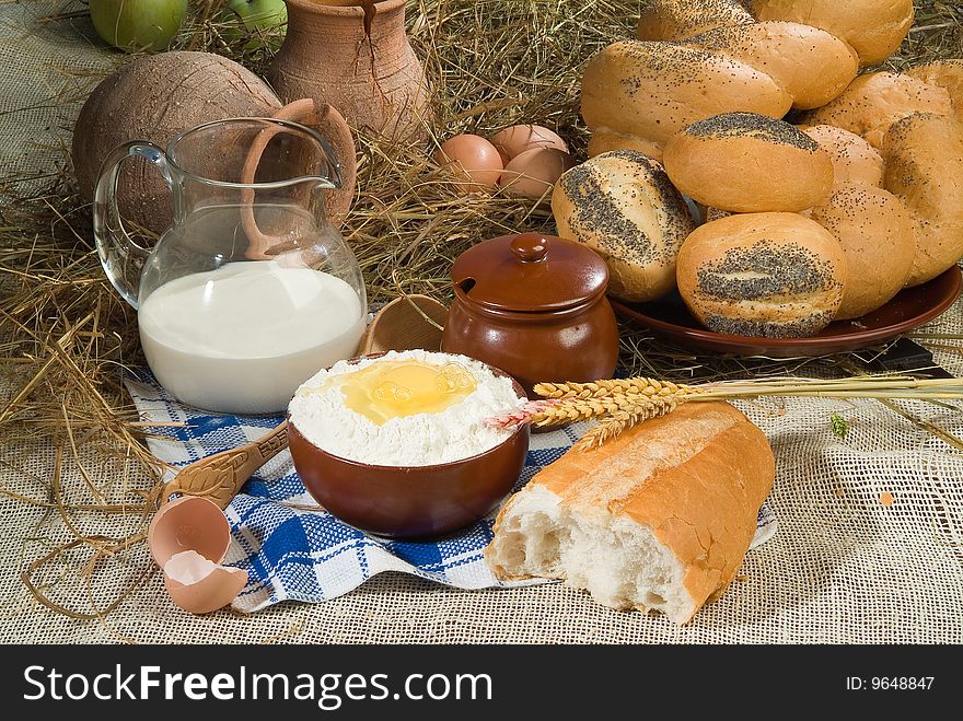 Bread, milk and ceramic on canvas tablecloth. Bread, milk and ceramic on canvas tablecloth