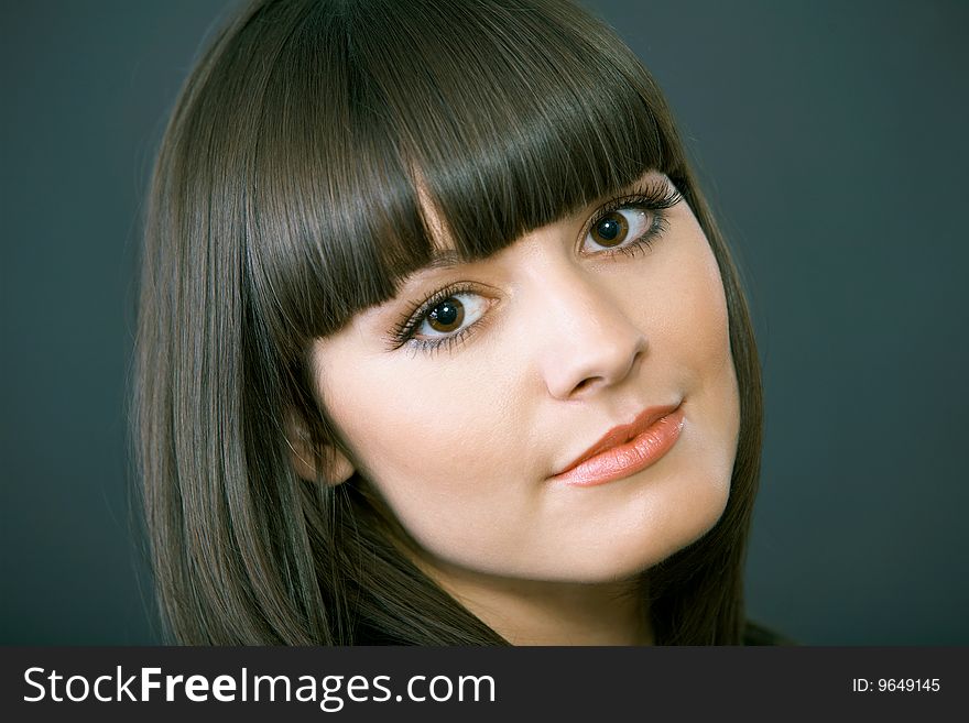 Close-up portrait of a beautiful woman on a black background