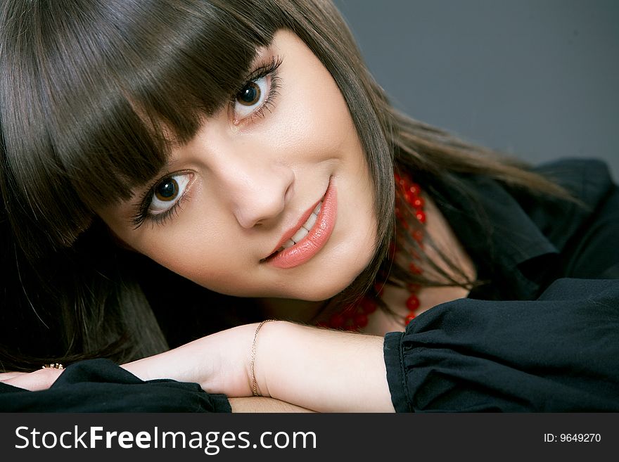 Close-up portrait of a beautiful woman on a black background