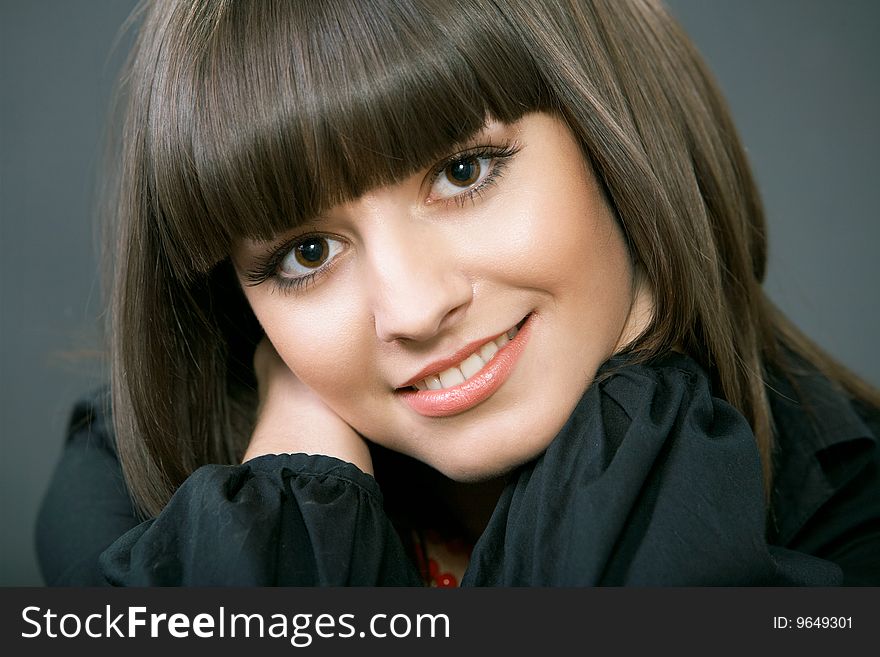 Close-up portrait of a beautiful woman on a black background