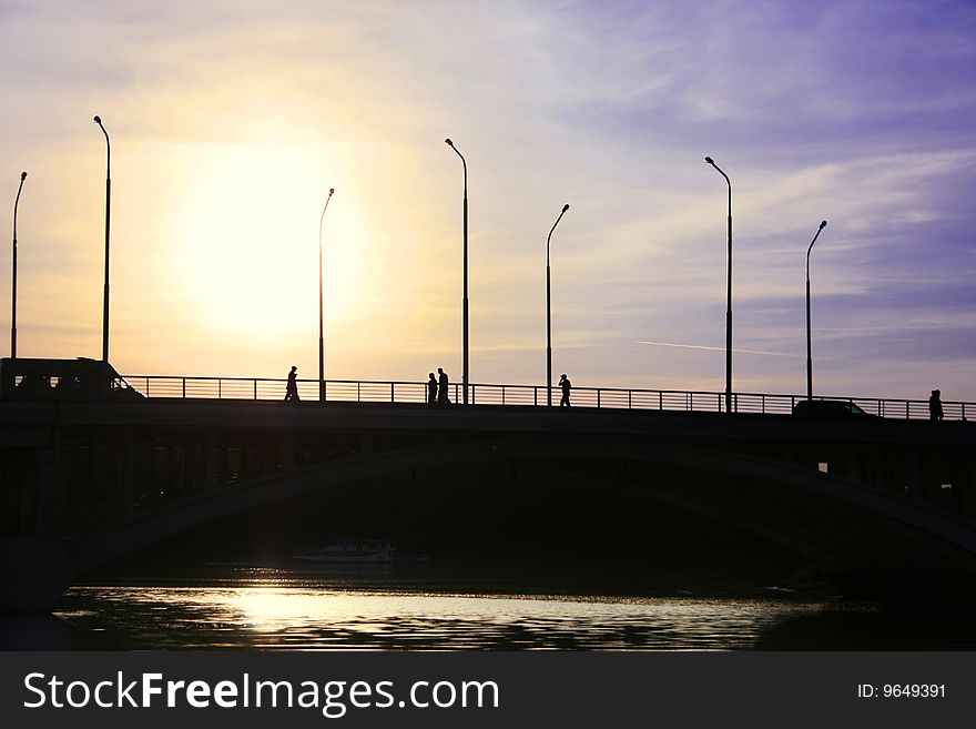 People cross over the bridge