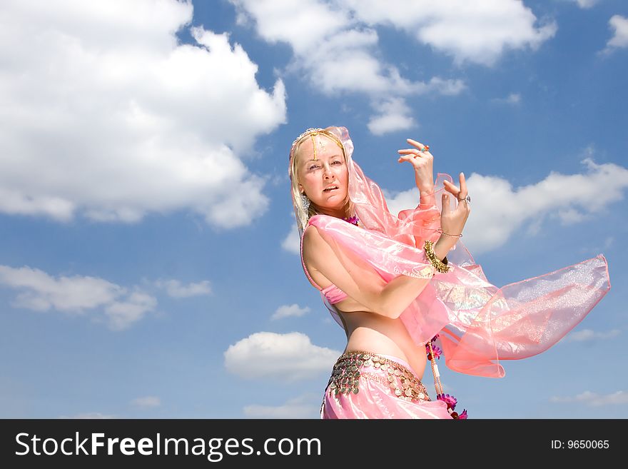 A Woman In Pink Dancing And A Blue Sky