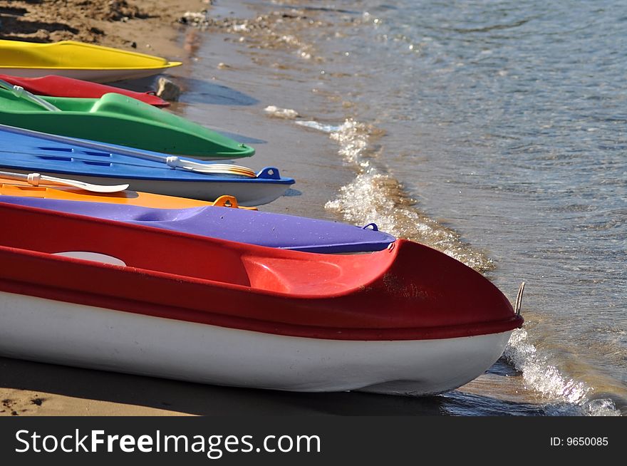 Colorful kayaks by the beach