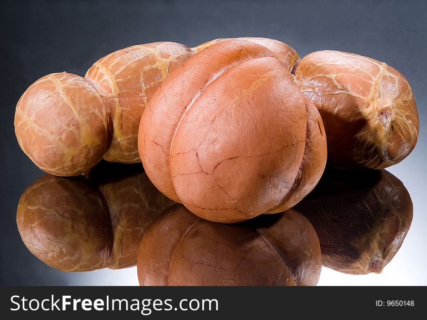 Sausages on a black glass background