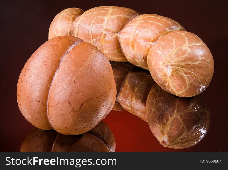 Sausages on a black glass background