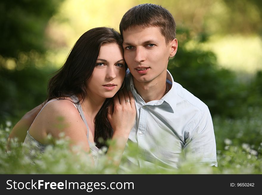 Man and woman sitting on the grass. Man and woman sitting on the grass.