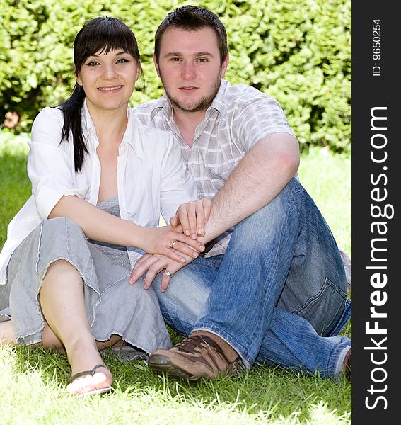 Happy loving couple together relaxing in garden