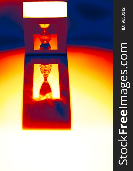 Still life of a backlighted hourglass, colorised. Still life of a backlighted hourglass, colorised.