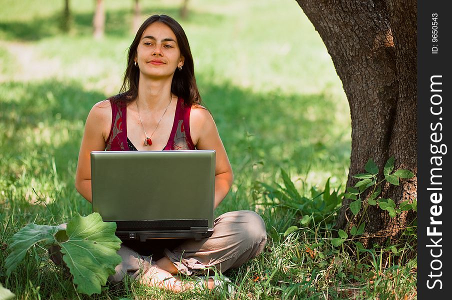 Young Woman Using Her Laptop Outdoors.