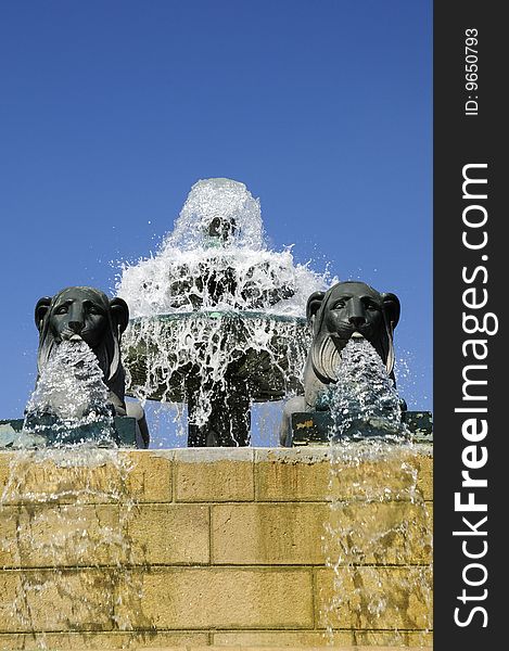Spraying fountain with lion statue in the blue sky. Spraying fountain with lion statue in the blue sky
