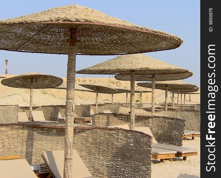 egyptian beach view with chairs and parasol of twisted cane