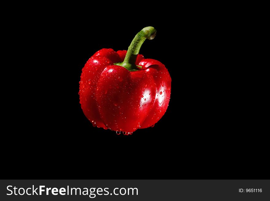 Red bulgarian pepper on black background. Red bulgarian pepper on black background