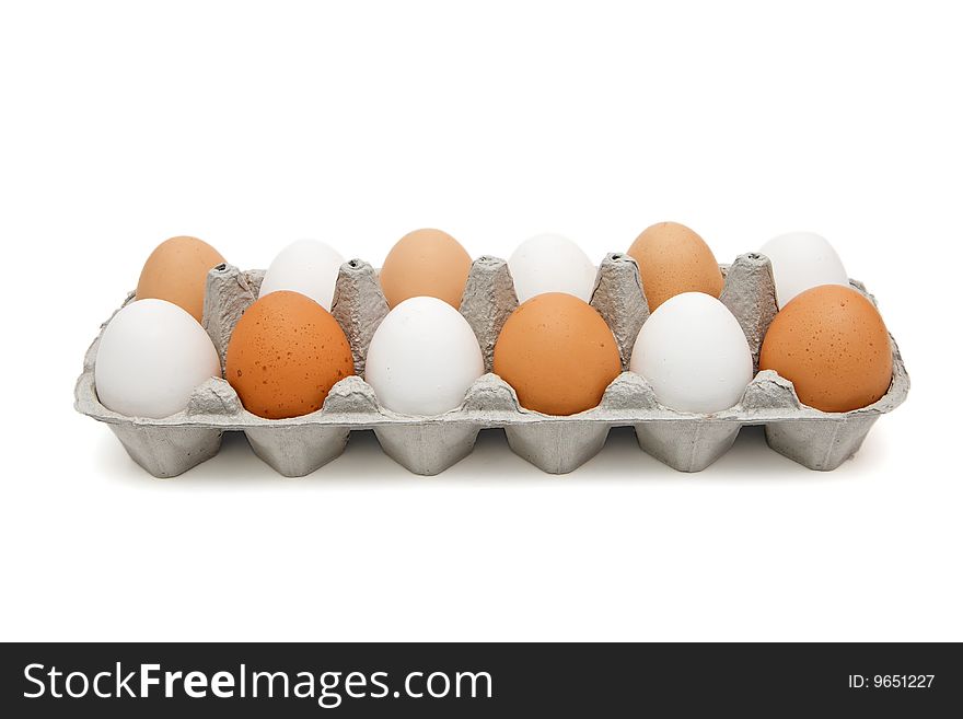 White and brown eggs in a paper box in a chessboard order isolated. White and brown eggs in a paper box in a chessboard order isolated