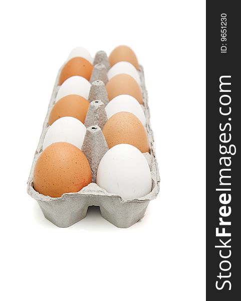 White and brown eggs in paper box isolated