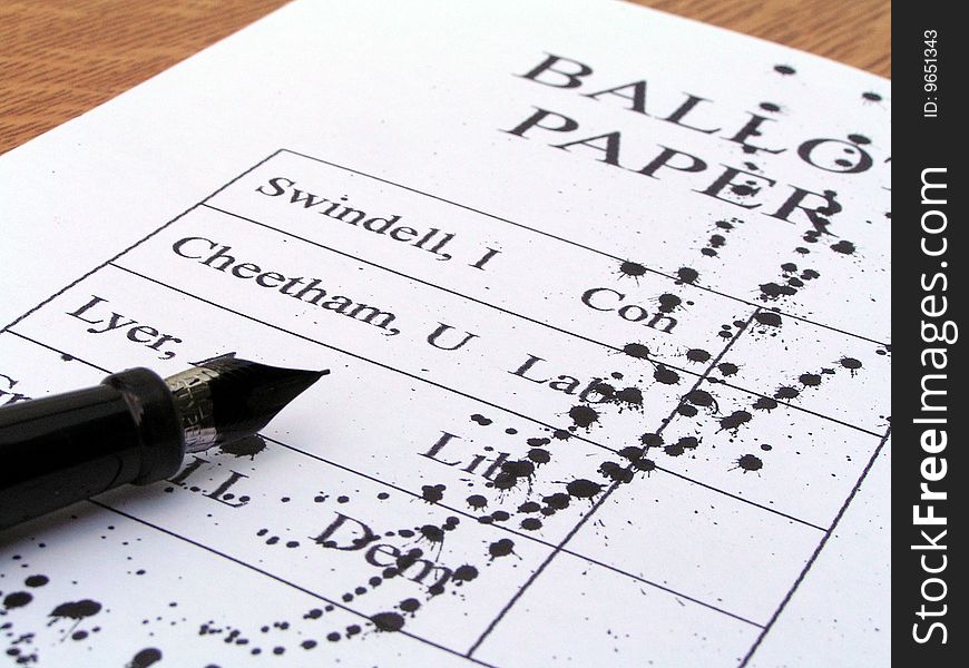 A pen rests on an ink splattered ballot paper. A pen rests on an ink splattered ballot paper