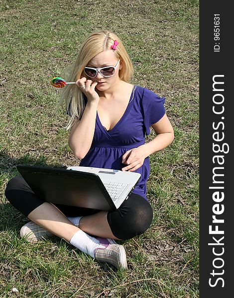 Busy student working on laptop outdoors