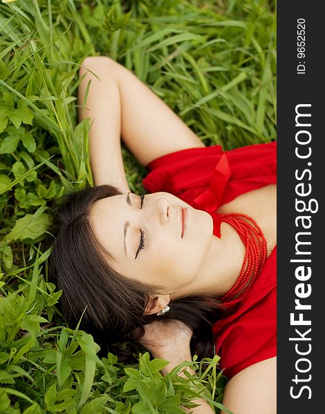 Beautiful girl lying on the grass