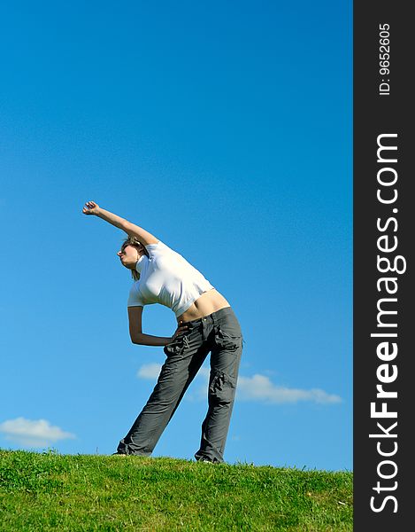 Girl doing morning exercises in the park