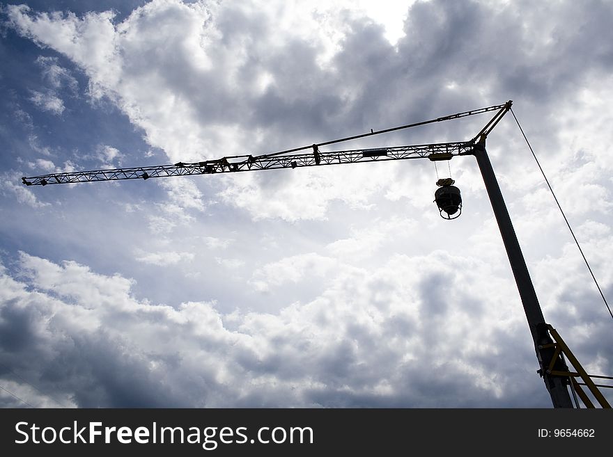 Silhouette of a crane over a cloudy sky. Silhouette of a crane over a cloudy sky