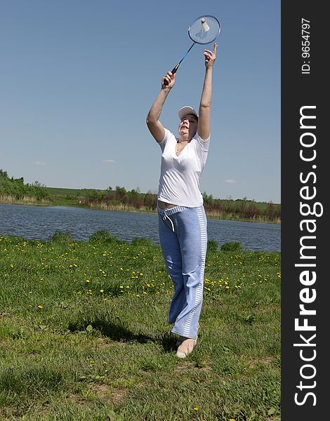 A young woman plays in a badminton. A young woman plays in a badminton