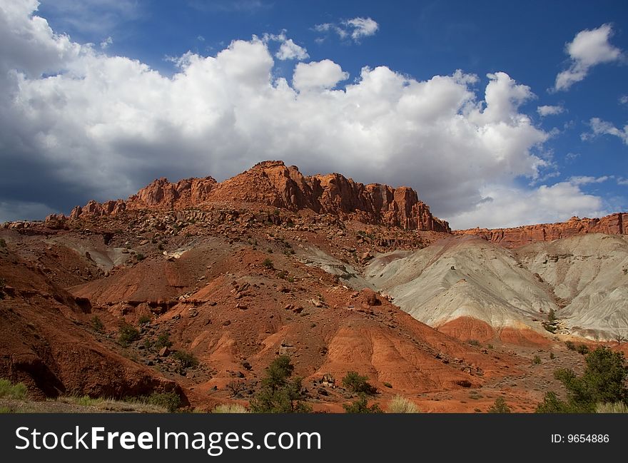 View of red rock formations in San Rafael Swell with blue skyï¿½s the and clouds